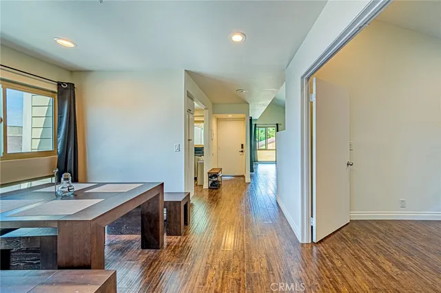a view of a hallway with wooden floor and furniture