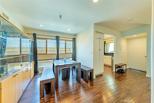a living room with furniture a wooden floor and a large window