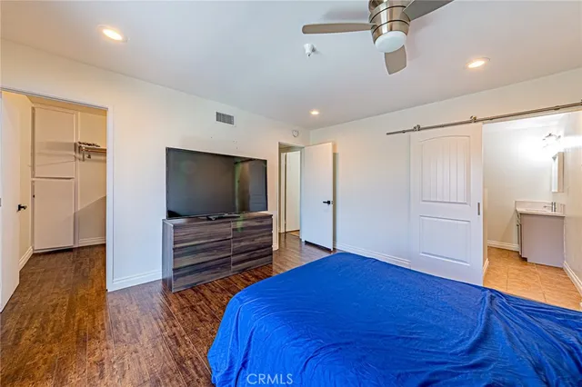 a bedroom with a bed and a flat screen tv