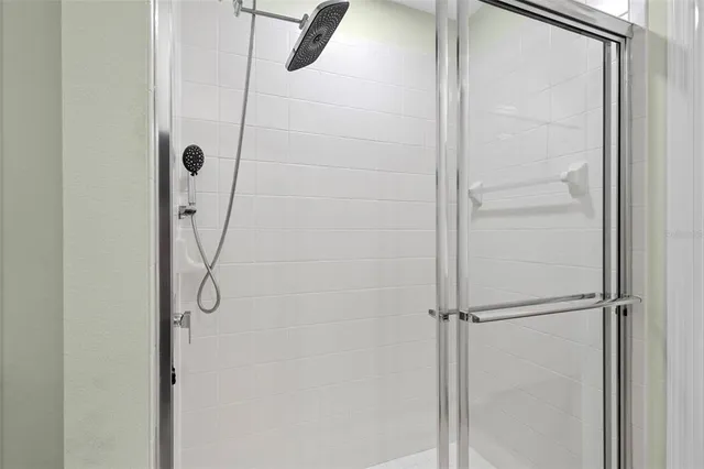 a bathroom with a glass shower door
