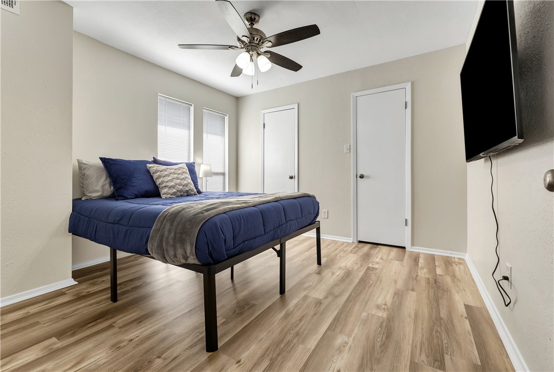 1516 Hawk Tree Drive, Unit C College Station, TX 77845 - Photo 11 of 15 a bedroom with a bed and a flat screen tv