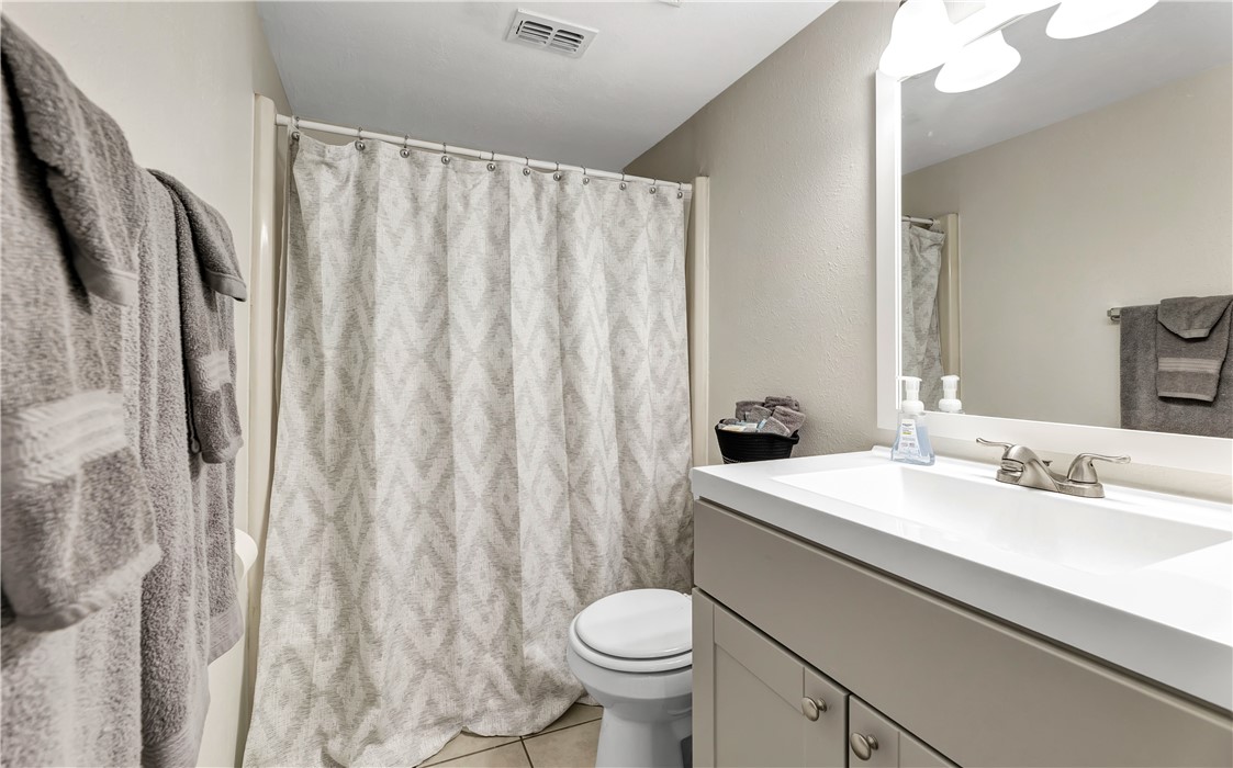 1516 Hawk Tree Drive, Unit C College Station, TX 77845 - Photo 12 of 15 a bathroom with a sink a toilet and a mirror