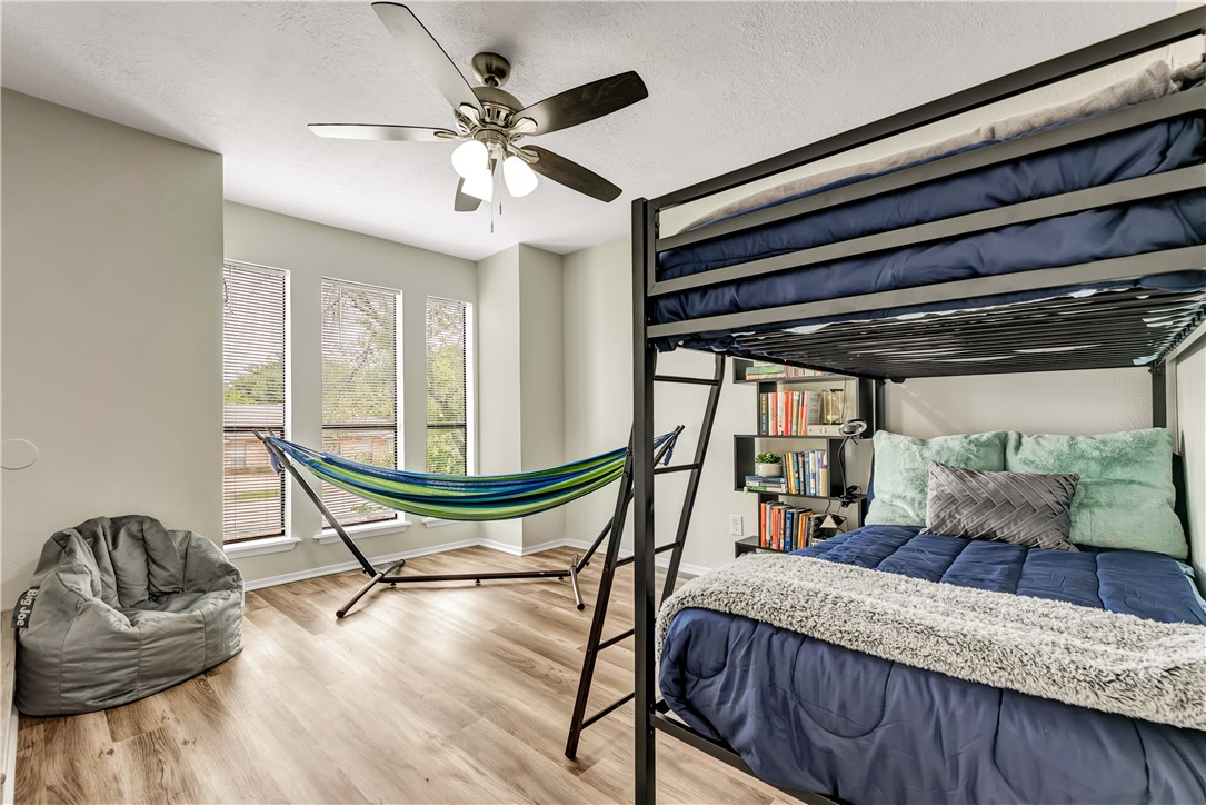 1516 Hawk Tree Drive, Unit C College Station, TX 77845 - Photo 13 of 15 a living room with furniture and a chandelier