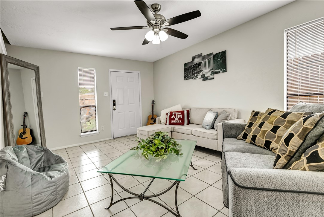1516 Hawk Tree Drive, Unit C College Station, TX 77845 - Photo 4 of 15 a living room with furniture and a large window
