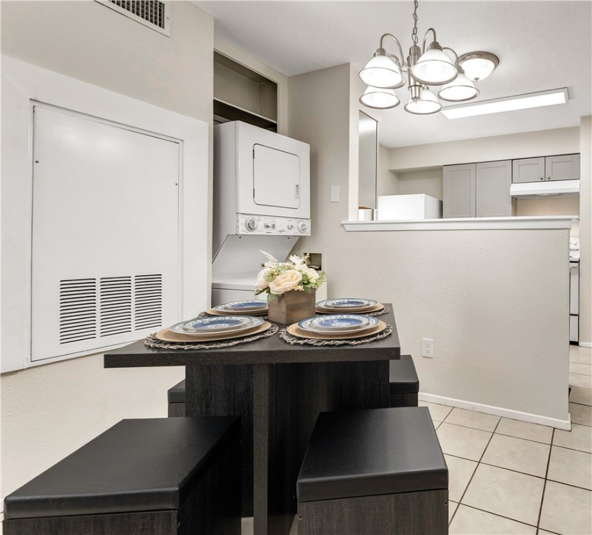 1516 Hawk Tree Drive, Unit C College Station, TX 77845 - Photo 7 of 15 a view of a dining room with furniture and chandelier