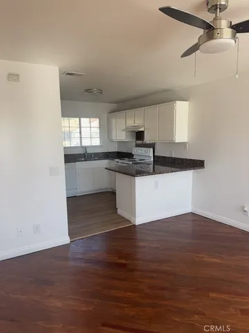 a kitchen with stainless steel appliances granite countertop a sink window and cabinets