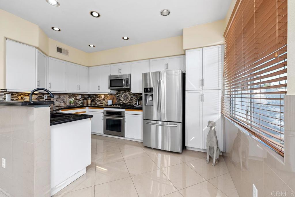 12490 Heatherton Court, Unit 8 San Diego, CA 92128 - Photo 12 of 30 a kitchen with a refrigerator a sink and a stove