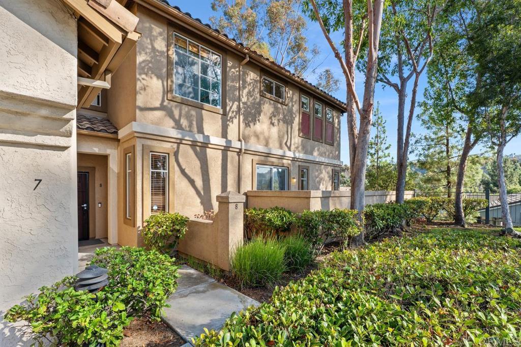 12490 Heatherton Court, Unit 8 San Diego, CA 92128 - Photo 2 of 30 a view of a house with a flower garden