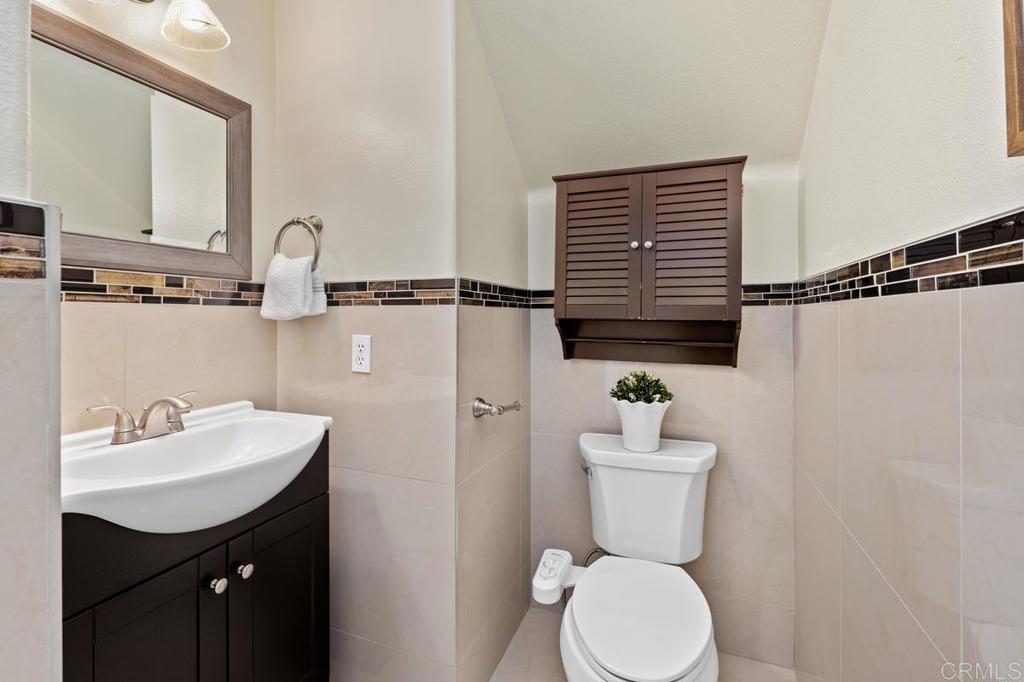 12490 Heatherton Court, Unit 8 San Diego, CA 92128 - Photo 22 of 30 a bathroom with a sink toilet and a mirror