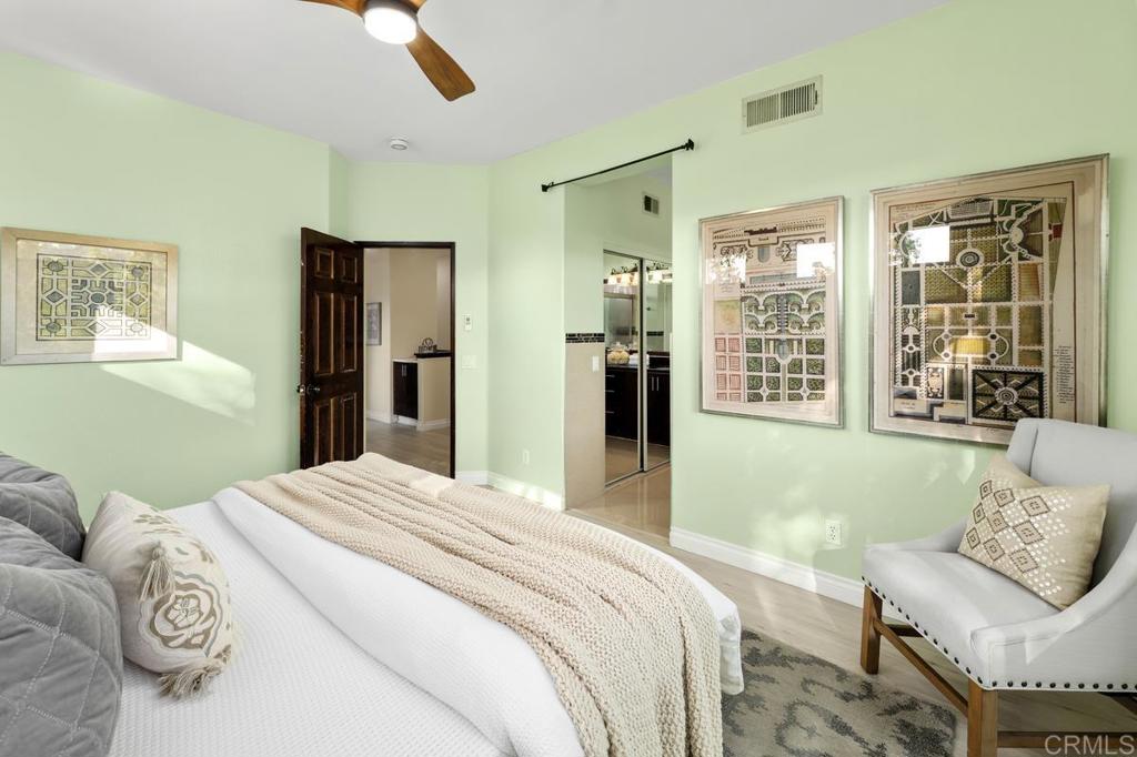 12490 Heatherton Court, Unit 8 San Diego, CA 92128 - Photo 24 of 30 a bedroom with a bed and a couch