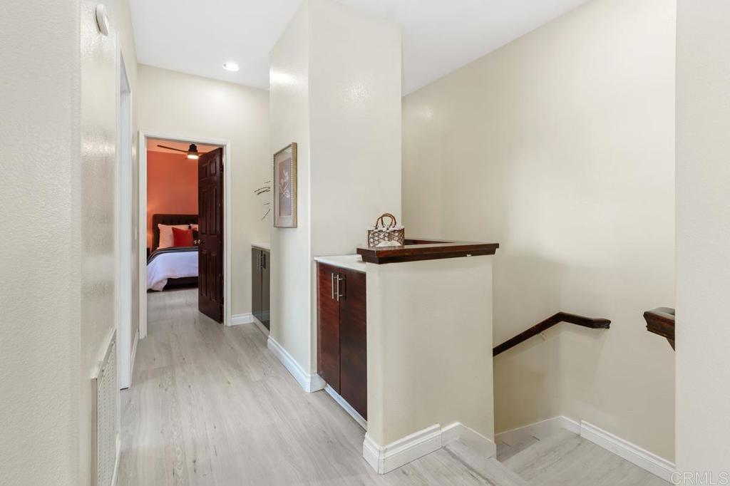 12490 Heatherton Court, Unit 8 San Diego, CA 92128 - Photo 27 of 30 a view of a hallway with wooden floor and closet