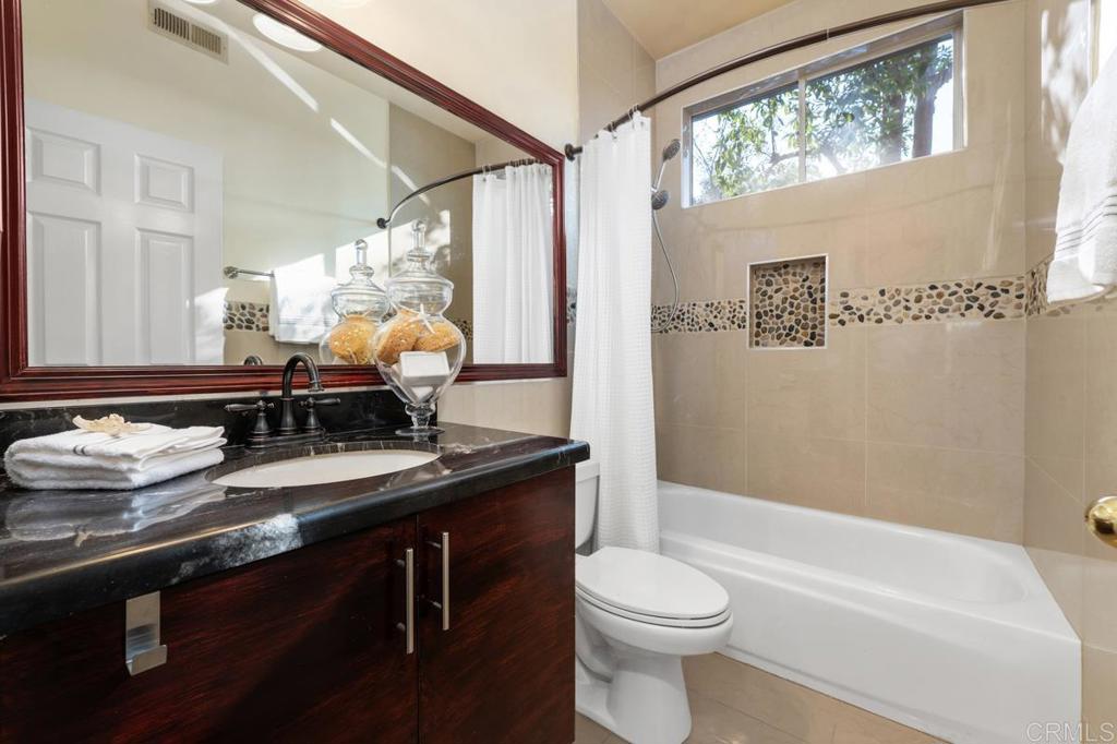 12490 Heatherton Court, Unit 8 San Diego, CA 92128 - Photo 30 of 30 a bathroom with a sink a toilet and a bathtub
