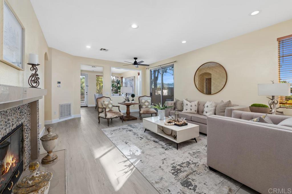 12490 Heatherton Court, Unit 8 San Diego, CA 92128 - Photo 7 of 30 a living room with furniture and a fireplace