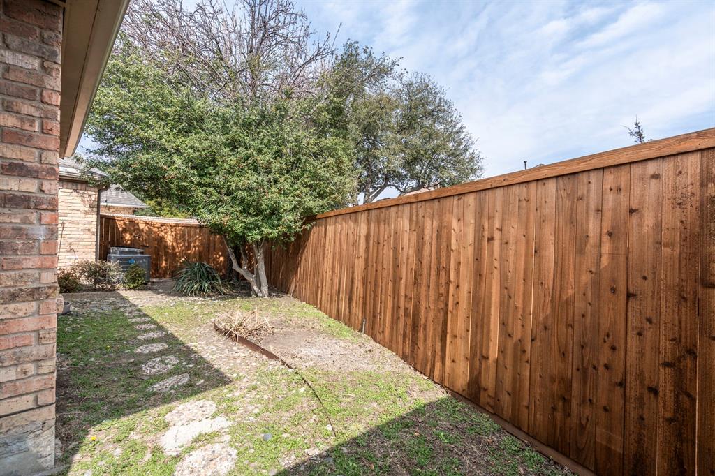 12616 Sunlight Drive Dallas, TX 75230 - Photo 34 of 40 a view of a backyard with wooden fence