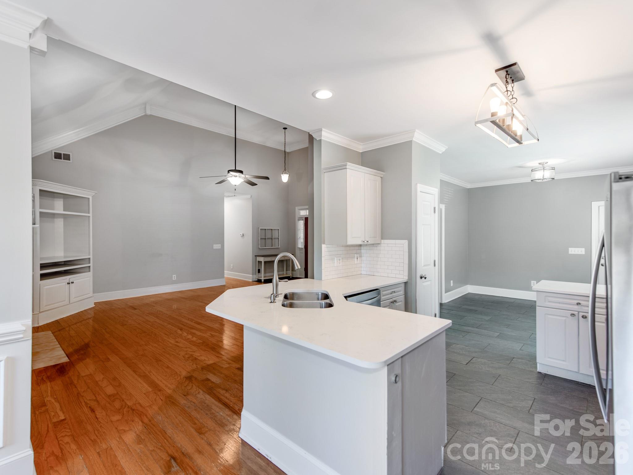 783 Sloan Street Denver, NC 28037 - Photo 6 of 44 a room with a sink a chandelier and wooden floor