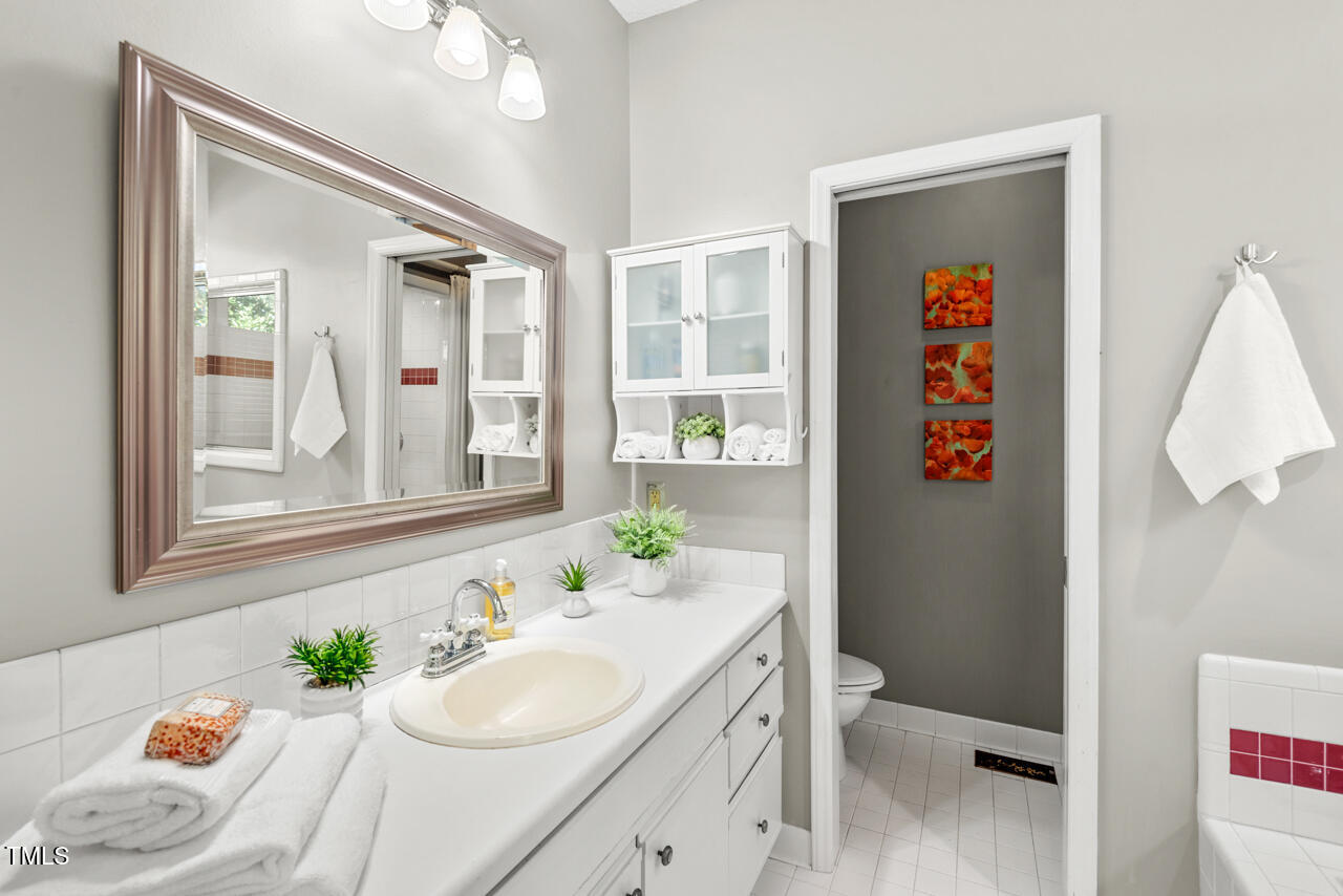 125 Legacy Lane Durham, NC 27713 - Photo 16 of 37 a bathroom with a sink vanity mirror and toilet