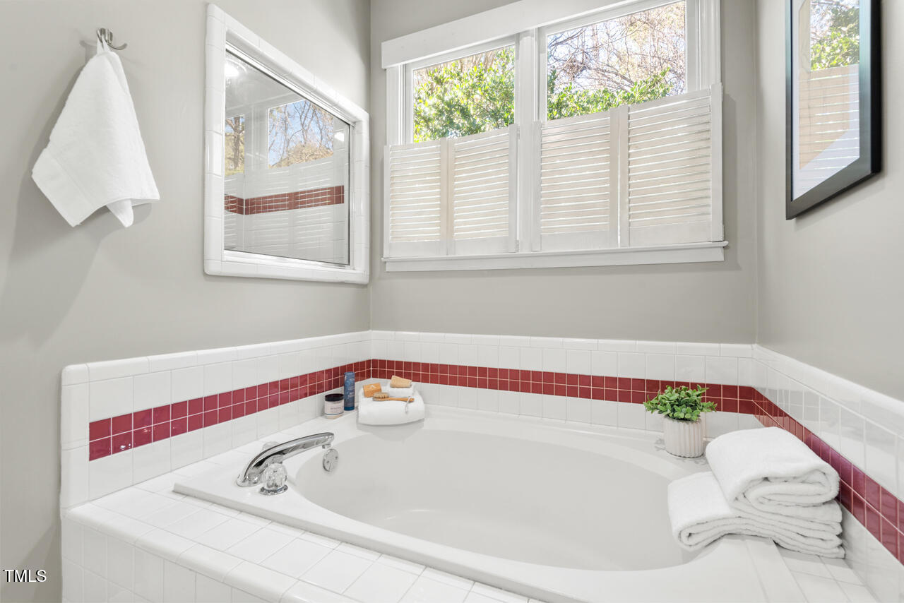 125 Legacy Lane Durham, NC 27713 - Photo 17 of 37 a bathroom with a bathtub and window