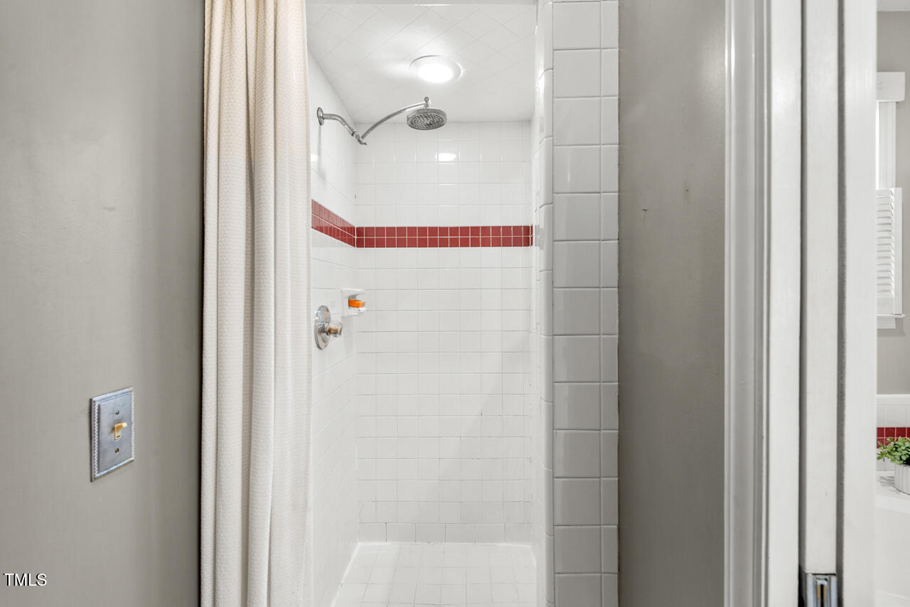 125 Legacy Lane Durham, NC 27713 - Photo 18 of 37 a bathroom with a glass shower door and a shower
