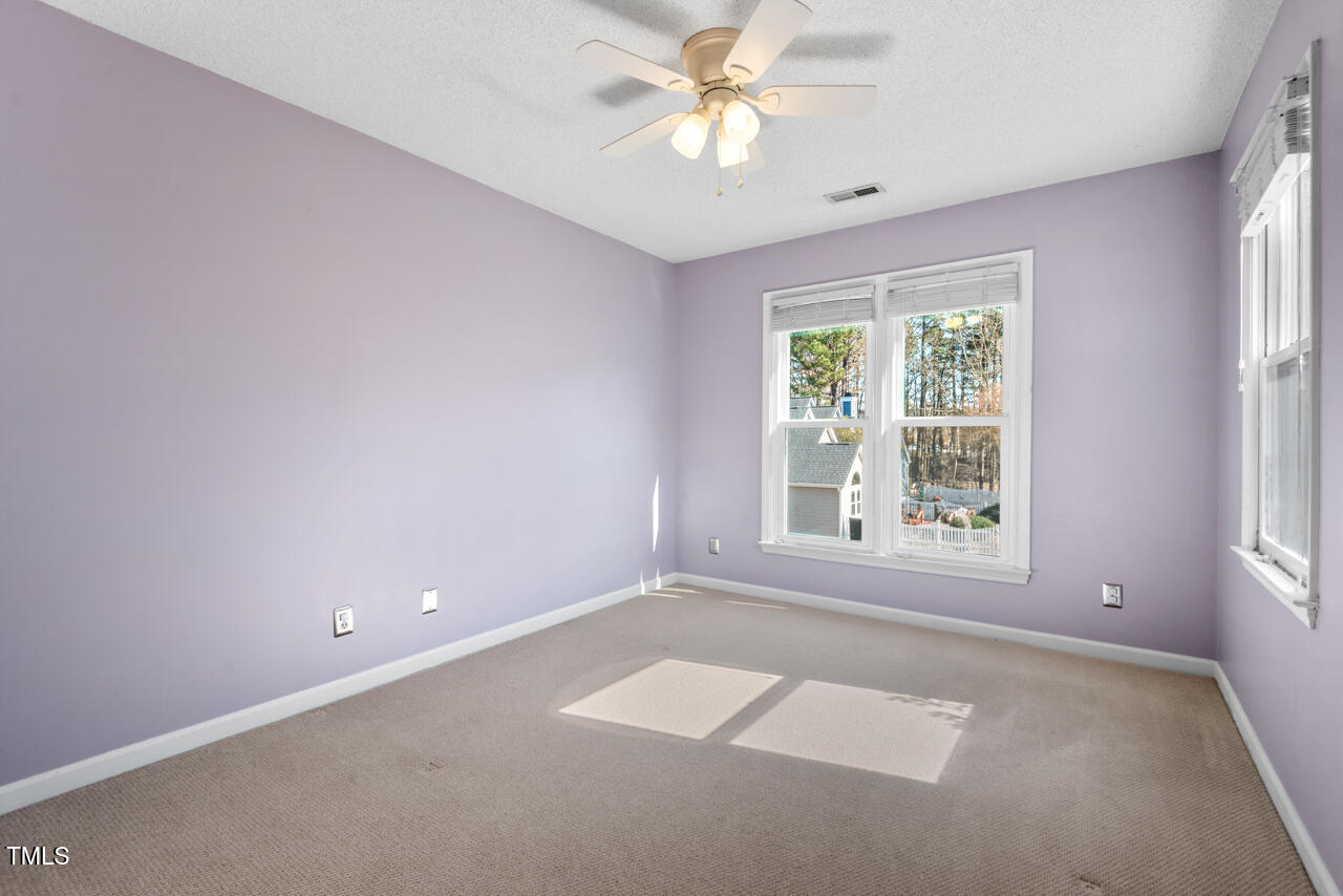 125 Legacy Lane Durham, NC 27713 - Photo 22 of 37 an empty room with a window and a fan