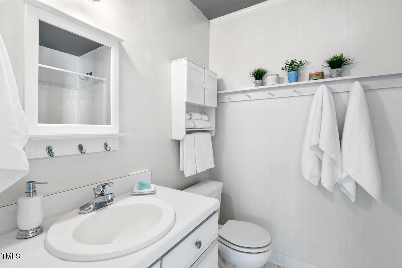 125 Legacy Lane Durham, NC 27713 - Photo 25 of 37 a bathroom with a sink a toilet and a mirror
