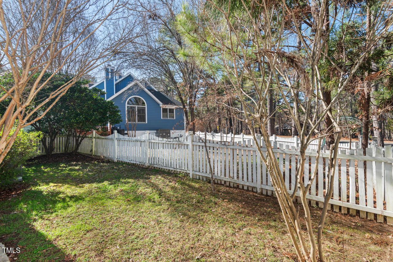 125 Legacy Lane Durham, NC 27713 - Photo 32 of 37 a view of a yard with a large tree and wooden fence