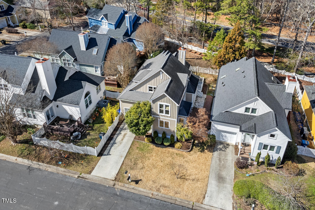 125 Legacy Lane Durham, NC 27713 - Photo 33 of 37 an aerial view of a residential apartment building with a yard and garage
