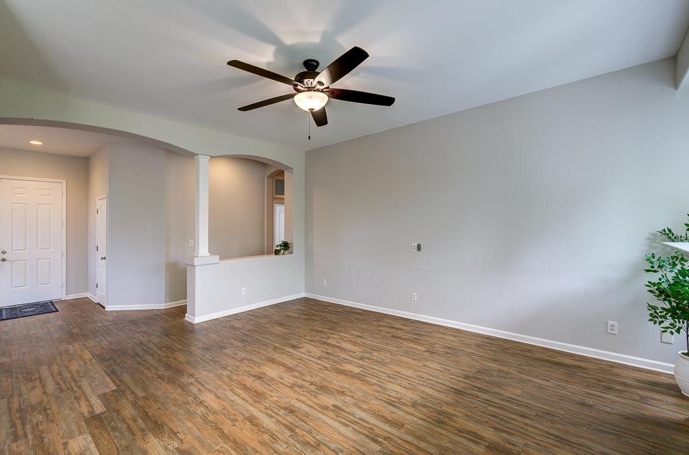 3235 Rall Avenue Clovis, CA 93619 - Photo 17 of 33 a view of a big room with wooden floor and windows