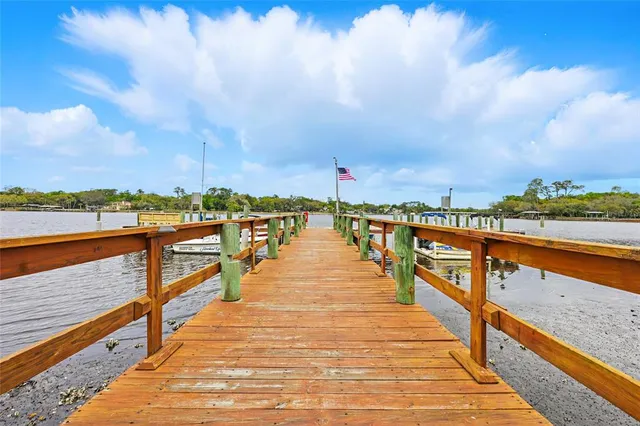 a wooden pier with view of boats