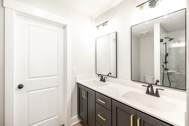 a bathroom with a double vanity sink and a mirror