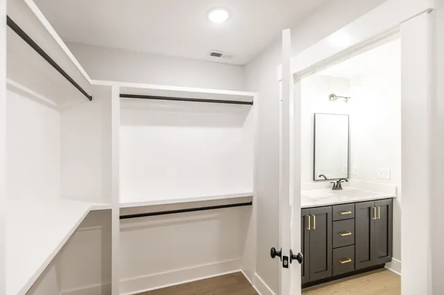 a bathroom with a shower sink and mirror
