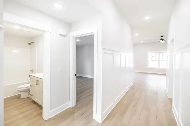 a view of a bathroom with toilet a bathtub and a shower