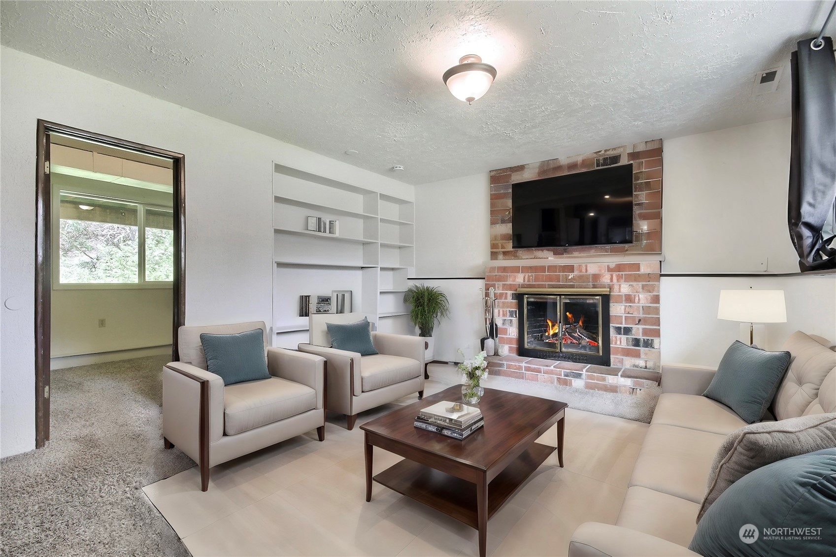 818 Haskell Street DuPont, WA 98327 - Photo 15 of 26 a living room with furniture a fireplace and a flat screen tv