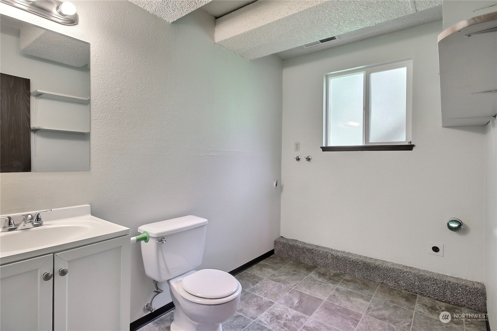 818 Haskell Street DuPont, WA 98327 - Photo 18 of 26 a white toilet sitting next to a bathroom sink