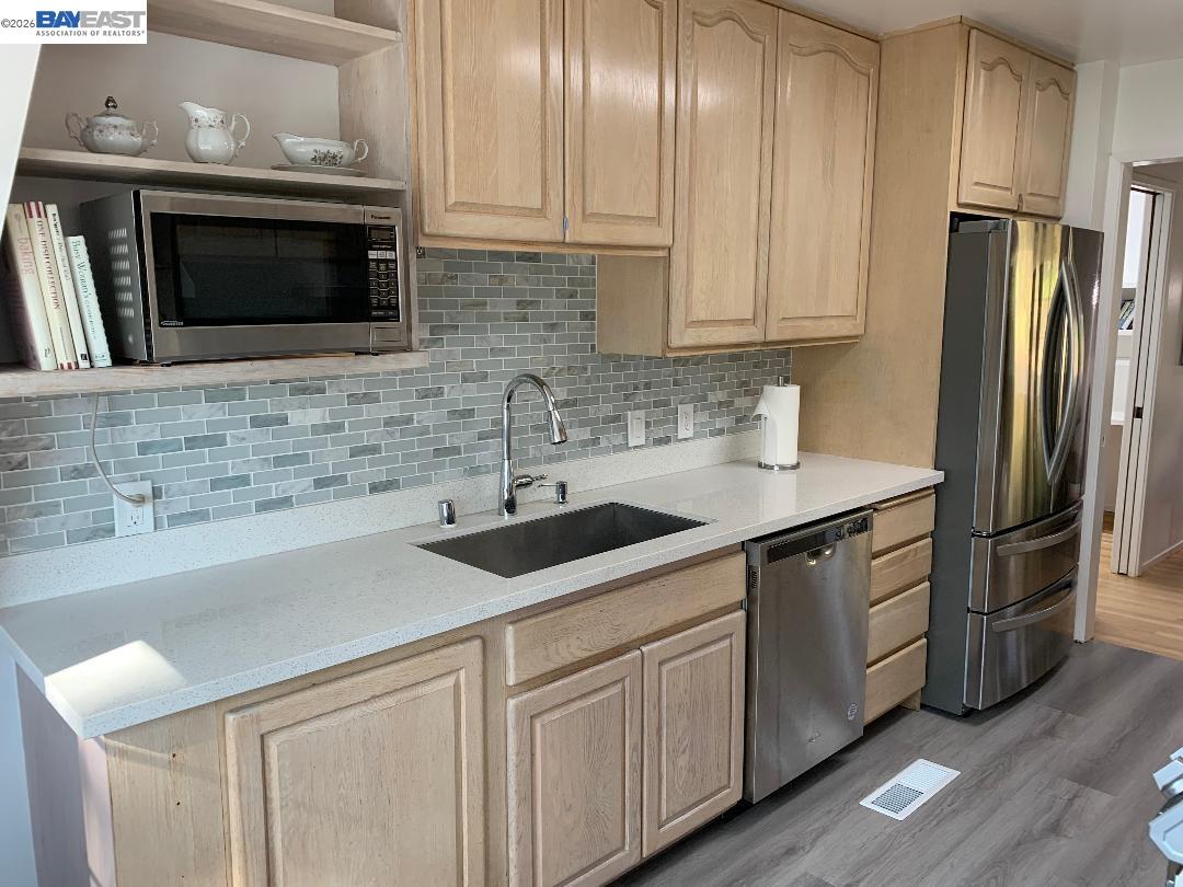 4515 Ewing Road Castro Valley, CA 94546 - Photo 13 of 41 a kitchen with stainless steel appliances granite countertop a sink stove and refrigerator