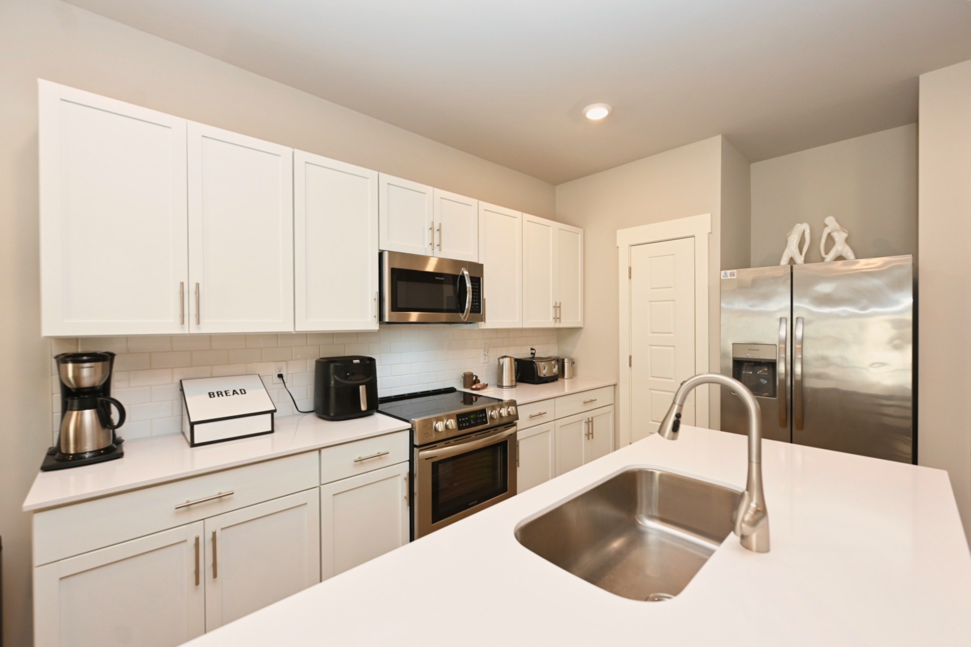 704 Mickelson Way Lebanon, TN 37087 - Photo 10 of 38 a kitchen with white cabinets sink and stainless steel appliances