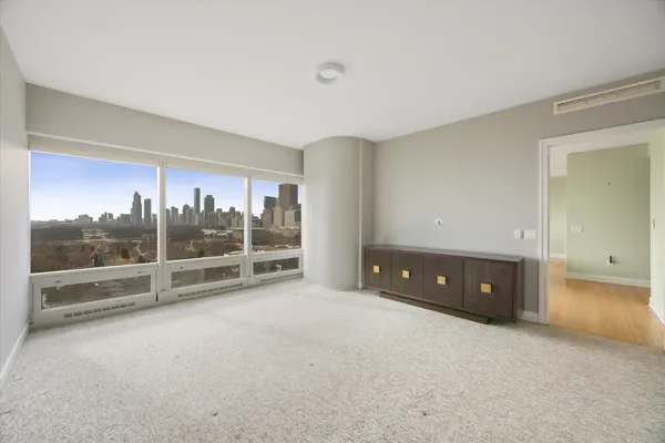 an empty room with sliding glass door and shower
