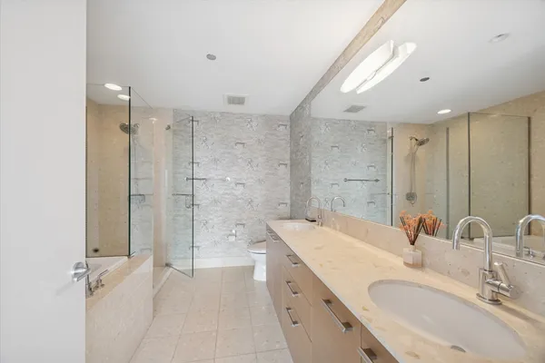a bathroom with a double vanity sink mirror double and shower