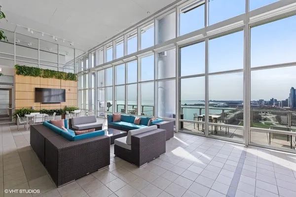 a living room with furniture city view and large windows