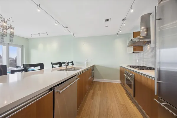 a kitchen with a sink a stove and a refrigerator