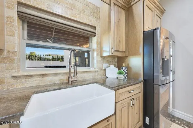 a kitchen with white cabinets and appliances