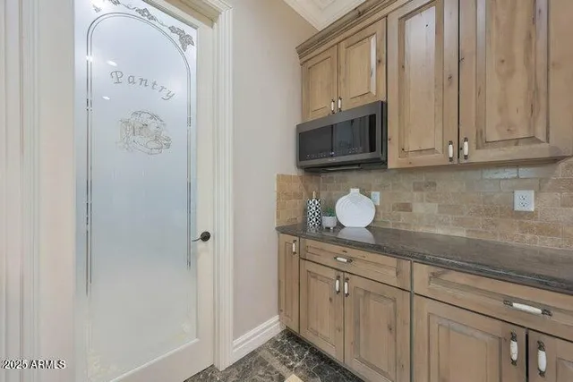 a kitchen with stainless steel appliances granite countertop white cabinets and refrigerator