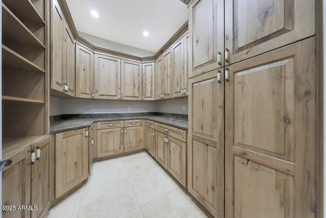 an empty room with windows and fireplace