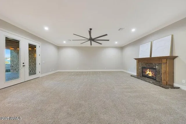 a view of a livingroom with a ceiling fan and window