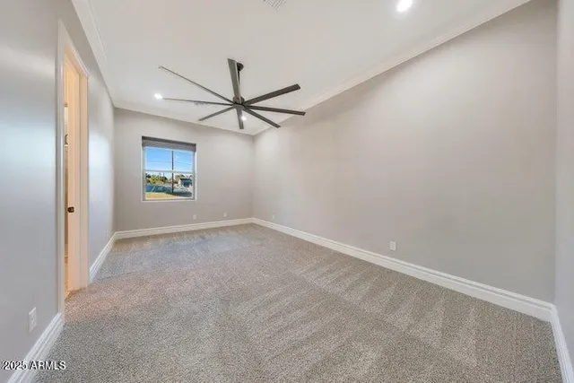 a spacious bathroom with a granite countertop sink toilet mirror and shower
