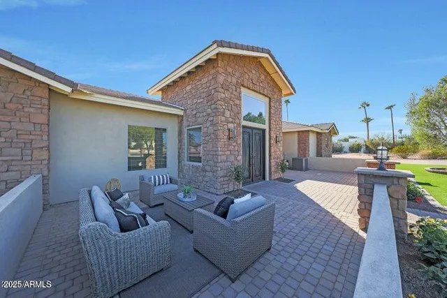 a outdoor space with patio the couches and a fireplace