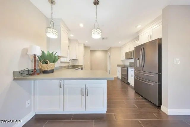 a kitchen with stainless steel appliances granite countertop a sink and dishwasher with wooden cabinets
