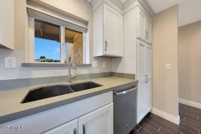 a view of a livingroom with wooden floor and a window