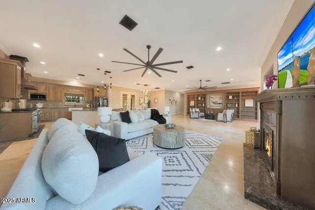a living room with furniture and kitchen view
