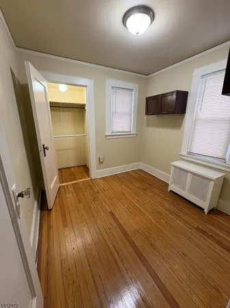 a view of a livingroom with wooden floor and stairs