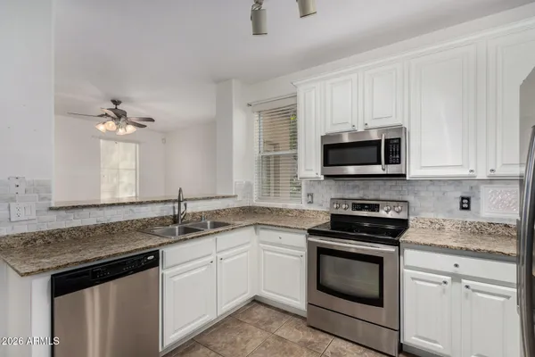 a kitchen with a sink stove and microwave
